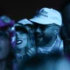 Lovebirds In the Limelight: Taylor Swift Lets Loose With Travis Kelce, Kissing And Dancing During Bleachers' Coachella set, "TRAVIS’ ARMS WRAPPED AROUND HER"