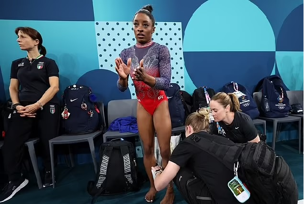 Simone Biles reveals the damage to her calf as she wears protective BOOT following painful end to Paris Olympics